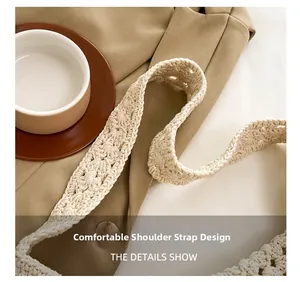 Detail of the woven shoulder strap on a beige tote bag showing high-quality craftsmanship
