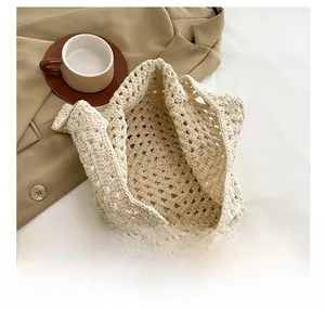 Detail show of beige woven tote bag featuring hollow mesh crochet texture and spacious design