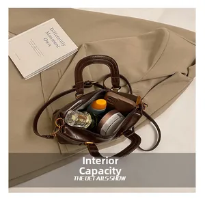 Interior view of dark brown vintage handbag showing space for phone and perfume