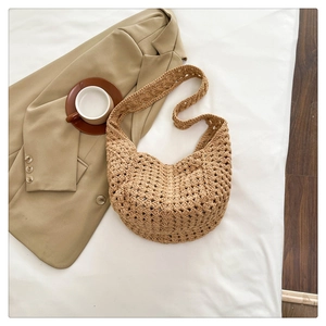 Detail of hand-woven hobo bag texture with integrated shoulder strap and minimalist design