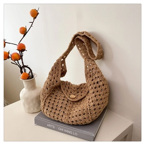 Detail view of woven shoulder bag with hollow knit texture and wooden button closure