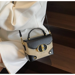 Detail of vintage mini crossbody box bag with two-tone design and gold metal clasp