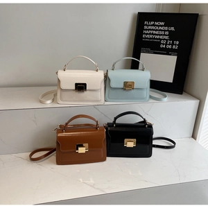 Structured square bags in four colors with gold metal square twist locks and top handles