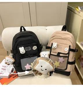 Close-up of cute cartoon toast plush pendant attached to a large capacity school backpack