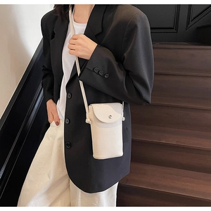 Close-up of cream white lychee grain leather crossbody phone bag with silver snap button