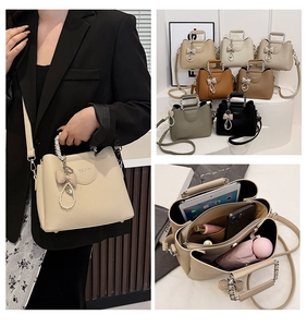 Detail view of leather handbag storage compartments with a chic pearl bow accessory