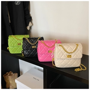 Detailed view of quilted crossbody bags in green, black, rose, and cream colors