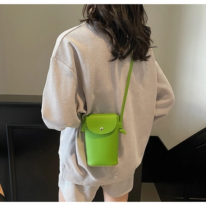 Close-up of a lime green litchi texture crossbody phone bag with silver snap button