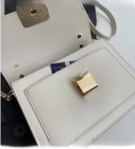 Detail view of the interior pocket showing storage capacity of the cream leather bag