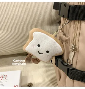 Close-up of cute plush toast charm with embroidery on a canvas backpack zipper