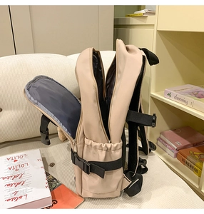 Side view of beige multi-compartment backpack with adjustable side buckles for commute