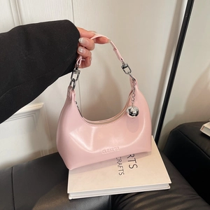 Détail du sac hobo rose avec bandoulière réglable et pendentif boule en métal argenté