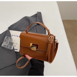 Top view of brown square PU leather handbag with gold metal lock and adjustable strap