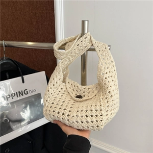 Woven crochet shoulder bag in cream white with a vintage bucket style and round buckle