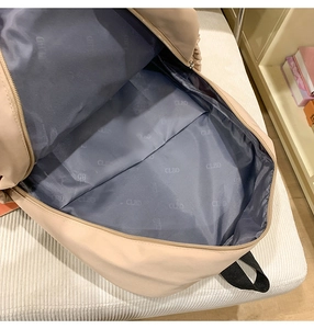 Detail view of large capacity backpack interior with durable branded lining and metal zipper