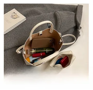 Interior view showing the large capacity and matching pouch of the beige tote bag
