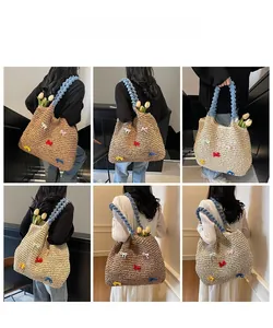 Detail of woven straw shoulder bag with colorful satin bows and blue plush straps