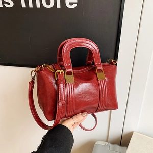 Vintage red glossy wrinkled leather satchel bag with retro gold hardware and top handle