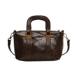 Vintage brown leather Boston bag with stitching detail and adjustable shoulder strap
