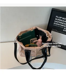 Top view of beige tote bag showing spacious interior with tablet, phone and umbrella