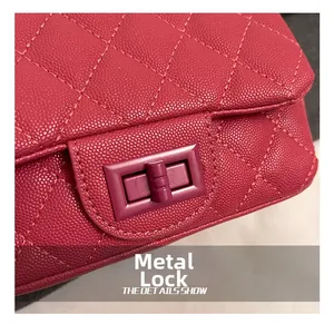 Macro shot of rose pink quilted leather handbag with gold metal twist-lock hardware detail