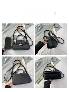 Detail view of black leather crossbody bag with scarf-wrapped handle and metal clasp