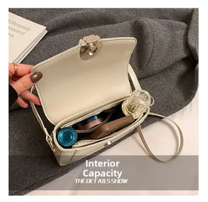 Beige saddle bag internal capacity detail showing phone and makeup accessories