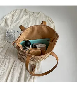 Spacious straw tote showing storage for tablet, phone, and daily essentials with lining