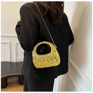 Detailed view of the gold ruched cloud bag featuring metallic texture and golden chain