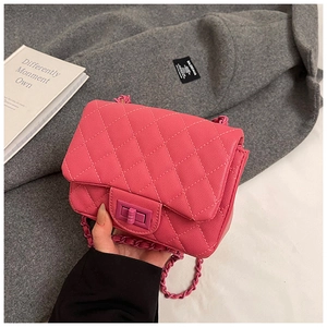 Detailed close-up of pink quilted leather bag with chain strap and square metal lock clasp
