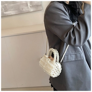 Détail d'un sac à main en perles tissées blanches avec doublure en satin et bandoulière