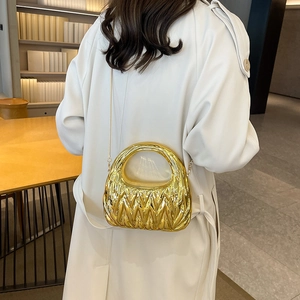 Chic gold pleated crescent clutch bag with metallic texture and sleek chain strap