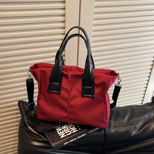 Classic dark red crossbody tote bag with black leather handles and silver hardware