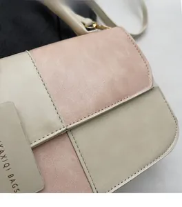 Close-up of pink and beige patchwork faux leather texture with fine stitching detail