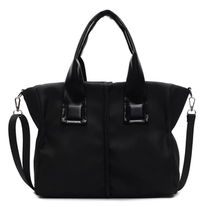 Minimalist black tote bag with smooth texture and adjustable shoulder strap for women