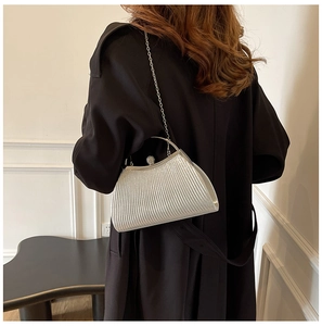 Silver pleated evening clutch bag with diamond-studded clasp on a chic metal chain