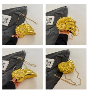 Detail of creative gold nautilus shell evening bag with luxury metallic finish and chain