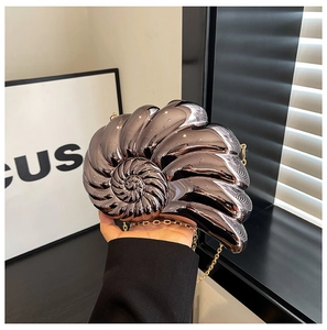 Detailed view of nautilus shell shape evening bag with grey metallic spiral texture