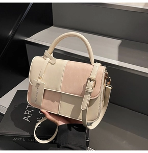 Detail of a pink and beige patchwork bag with matte texture and top handle