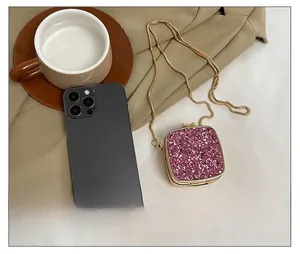 Detailed comparison showing pink sequin mini chain bag size next to a smartphone