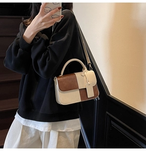 Detail of vintage patchwork crossbody bag in cream and brown with detachable strap