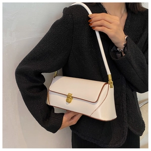 On-body view of cream PU leather baguette bag with vintage gold metal clasp and strap