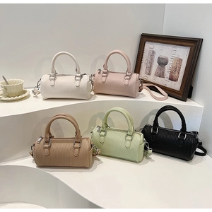 Five elegant cylinder boston bags in pastel colors with textured leather finish