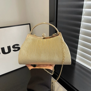 Champagne gold evening bag with ripple texture, metal handle and diamond-encrusted clasp