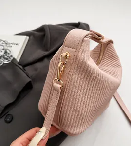 Detail of light pink pleated leather texture and durable gold metal hardware clasp