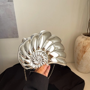 Silver nautilus shell clutch bag with metallic chain strap for evening parties