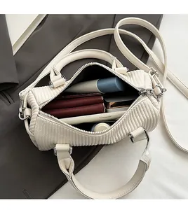 Interior view of spacious cream barrel bag showing room for phone and wallet