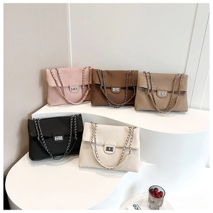 Detail view of five colors of pleated tote bags with silver rotating metal clasps