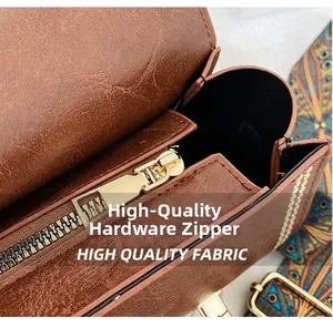Detail of premium hardware zipper and colorful woven strap on retro brown leather bag