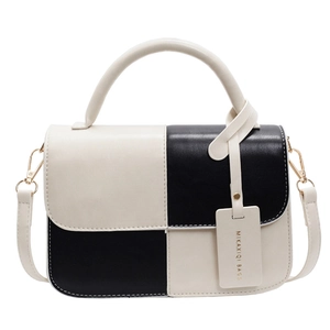 Chic black and white colorblock handbag with round handle and detachable shoulder strap